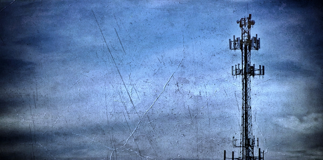 Tall telecommunication tower against a cloudy sky representing AIS 4G network failure and obsolescence in Thailand