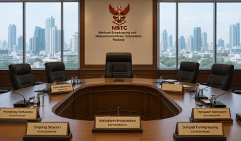 Empty chairman's chair at the head of the official NBTC conference table surrounded by commissioners' nameplates after the NBTC chairman removal.